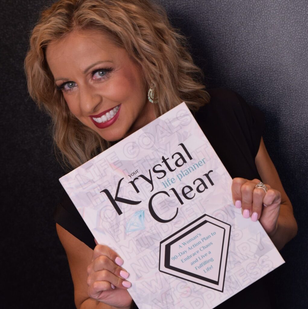 Krystalore Crews smiling and holding the Krystal Clear Life Planner